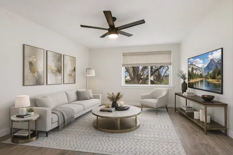a living room with furniture and a flat screen tv with wooden floor
