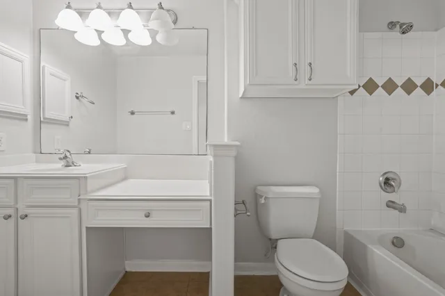 a bathroom with a sink a toilet and bathtub