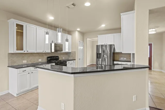 a kitchen with stainless steel appliances granite countertop a sink and cabinets