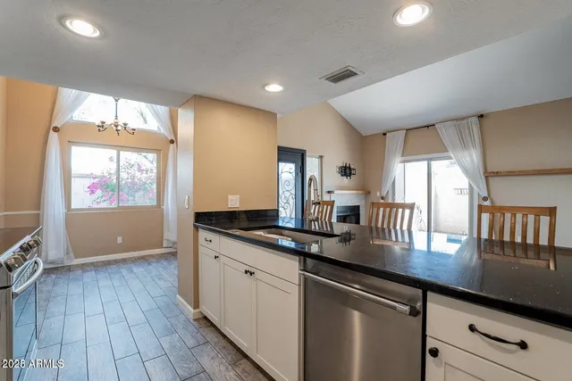 a kitchen with a sink and a stove top oven