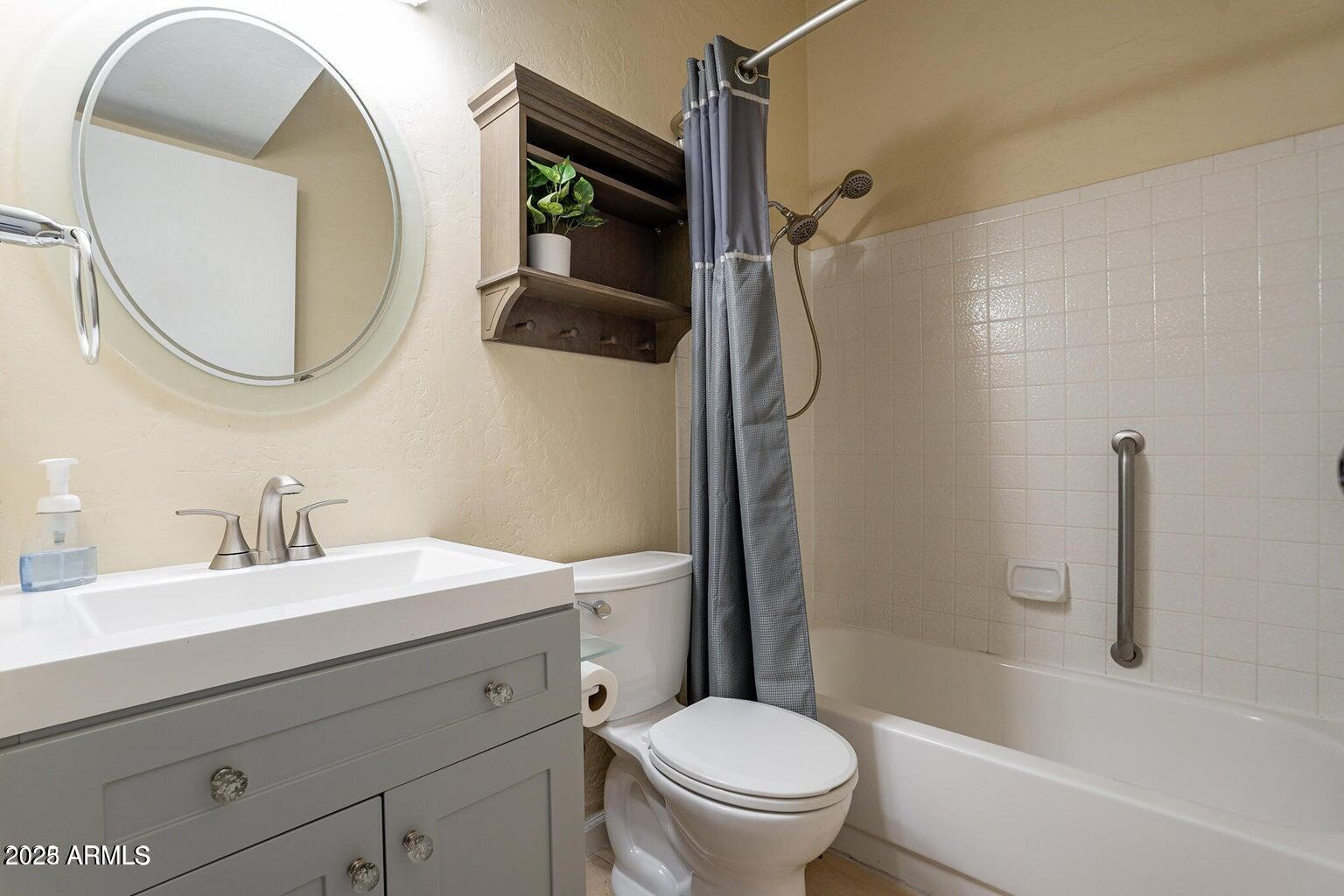 2019 West Lemon Tree Place, Unit 1115 Chandler, AZ 85224 - Photo 15 of 18 a bathroom with a sink a toilet and a mirror