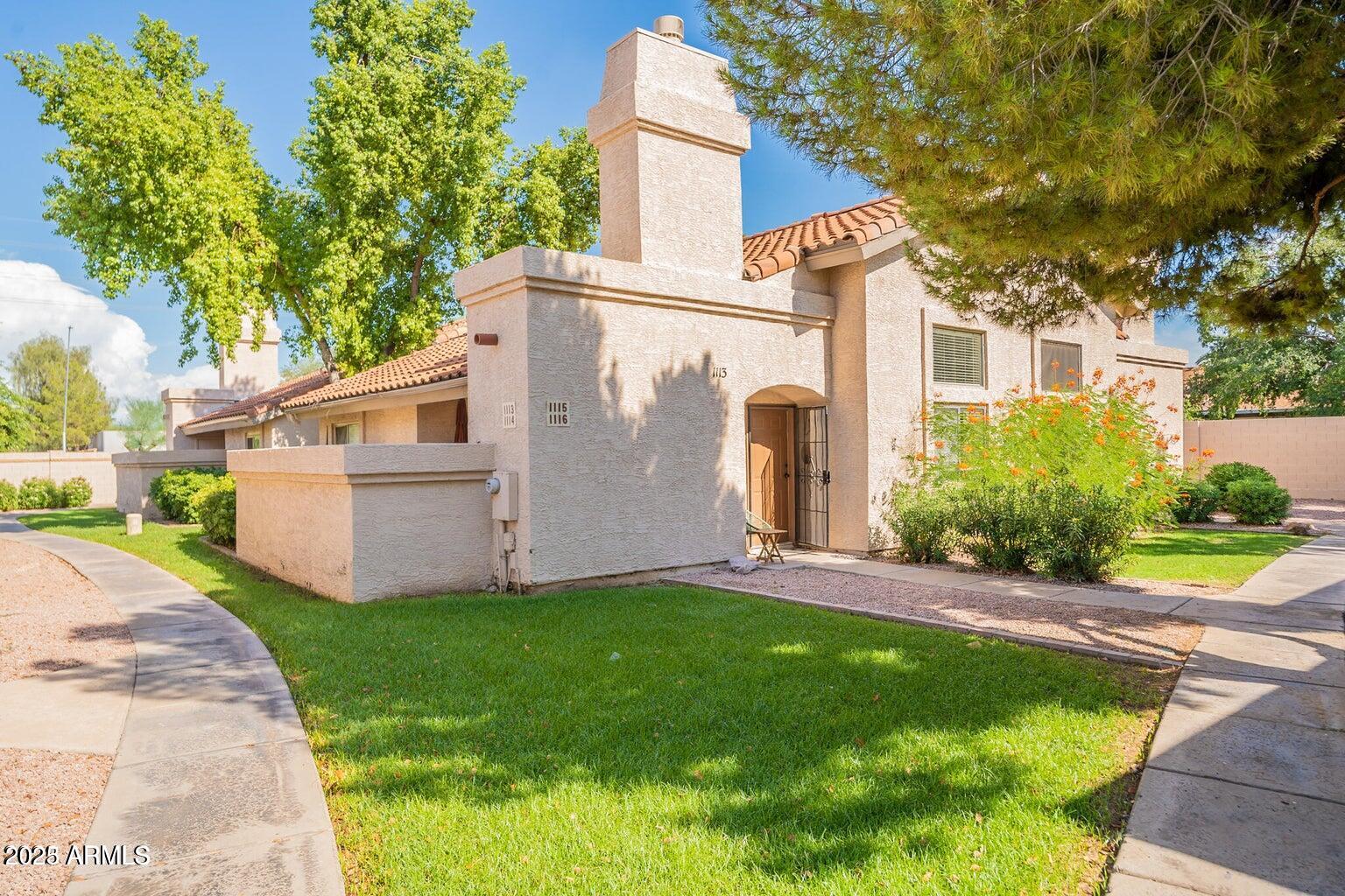 2019 West Lemon Tree Place, Unit 1115 Chandler, AZ 85224 - Photo 2 of 18 a view of a house with a yard
