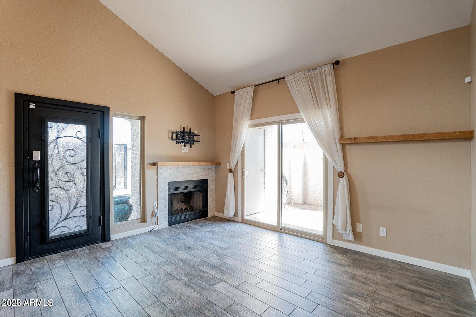 2019 West Lemon Tree Place, Unit 1115 Chandler, AZ 85224 - Photo 4 of 18 wooden floor fireplace and natural light in room