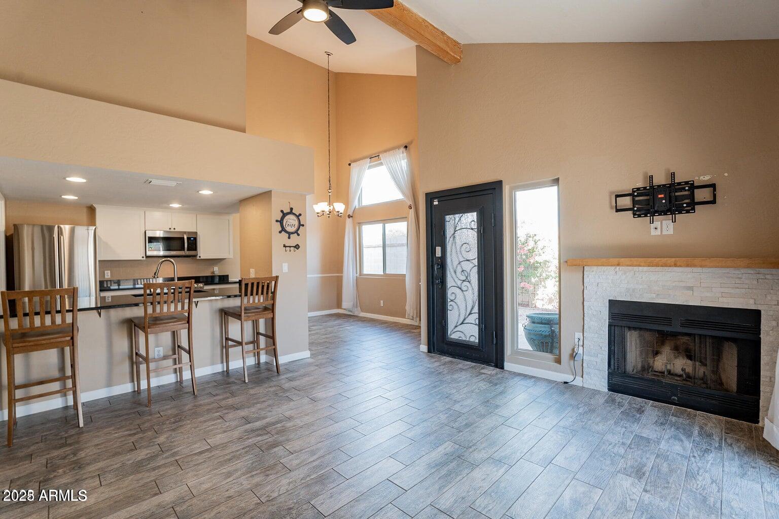 2019 West Lemon Tree Place, Unit 1115 Chandler, AZ 85224 - Photo 6 of 18 a view of a kitchen with furniture and a fireplace