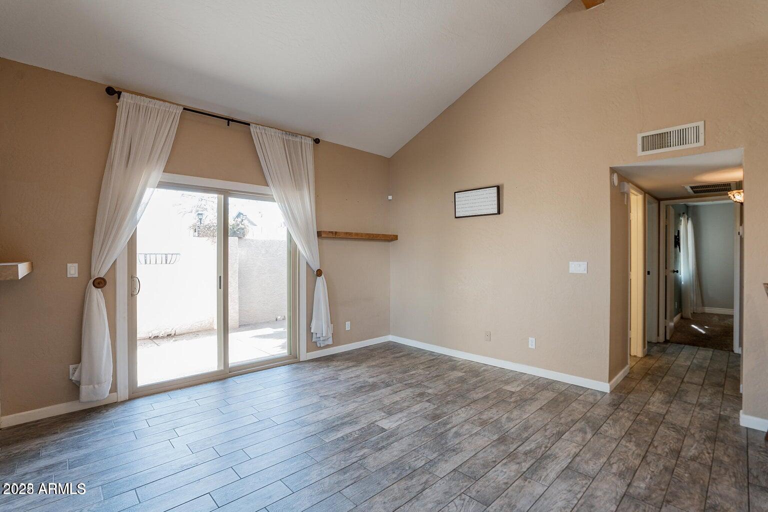2019 West Lemon Tree Place, Unit 1115 Chandler, AZ 85224 - Photo 7 of 18 a view of an empty room with glass door and a window