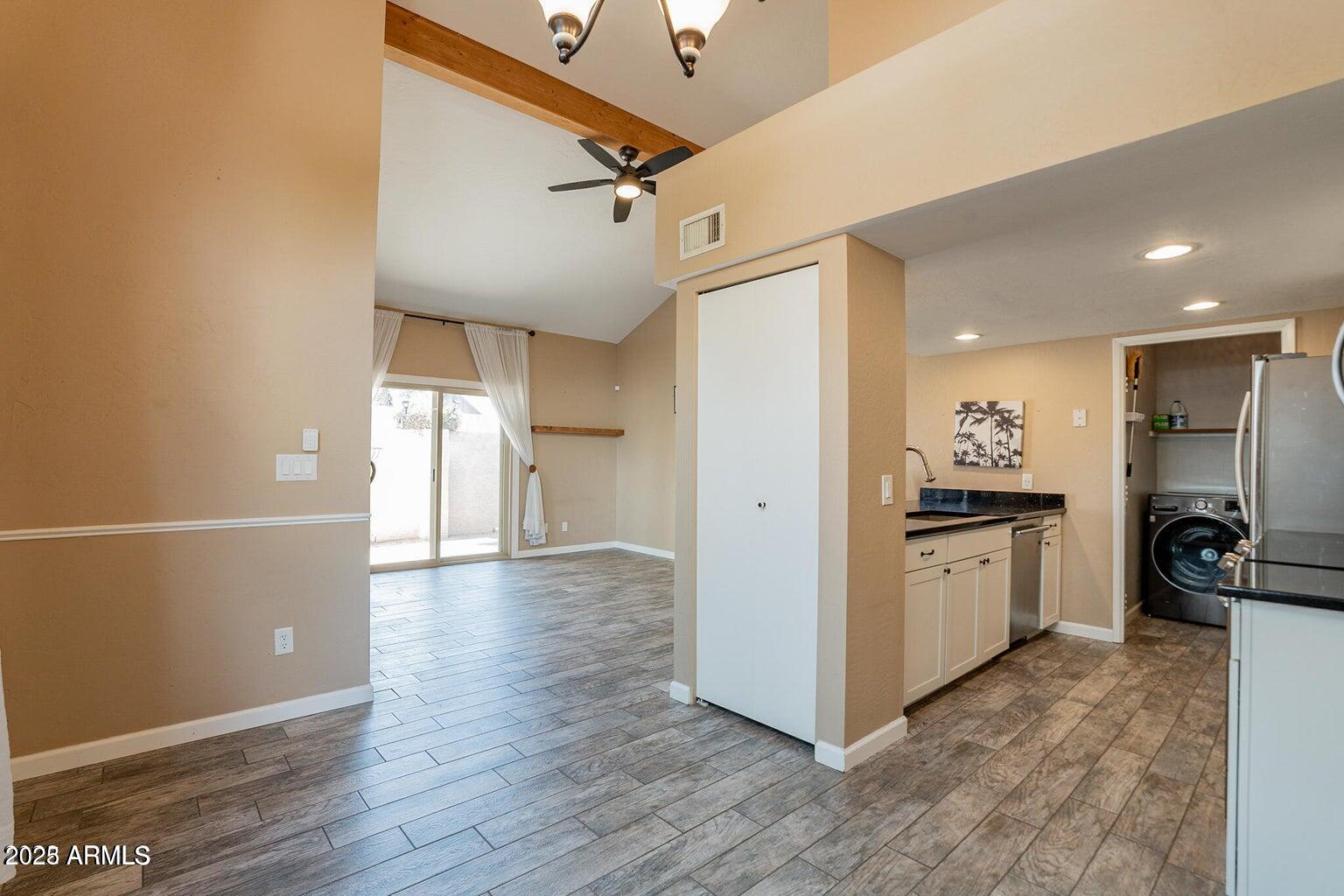 2019 West Lemon Tree Place, Unit 1115 Chandler, AZ 85224 - Photo 8 of 18 a view of a kitchen with a sink and a refrigerator