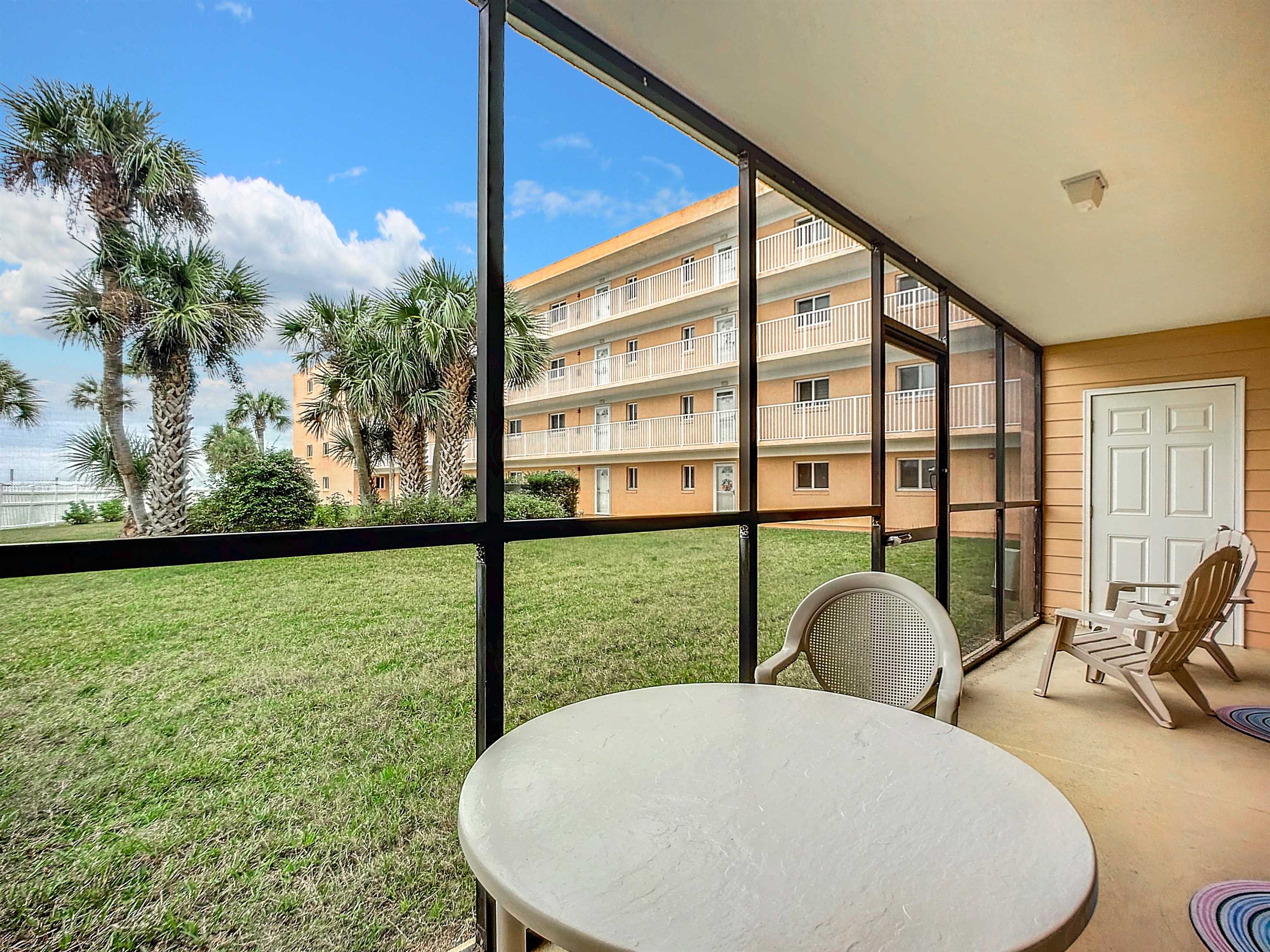 4 Ocean Trace Road, Unit 123 St. Augustine, FL 32080 - Photo 17 of 30 a view of a living room and floor to ceiling window