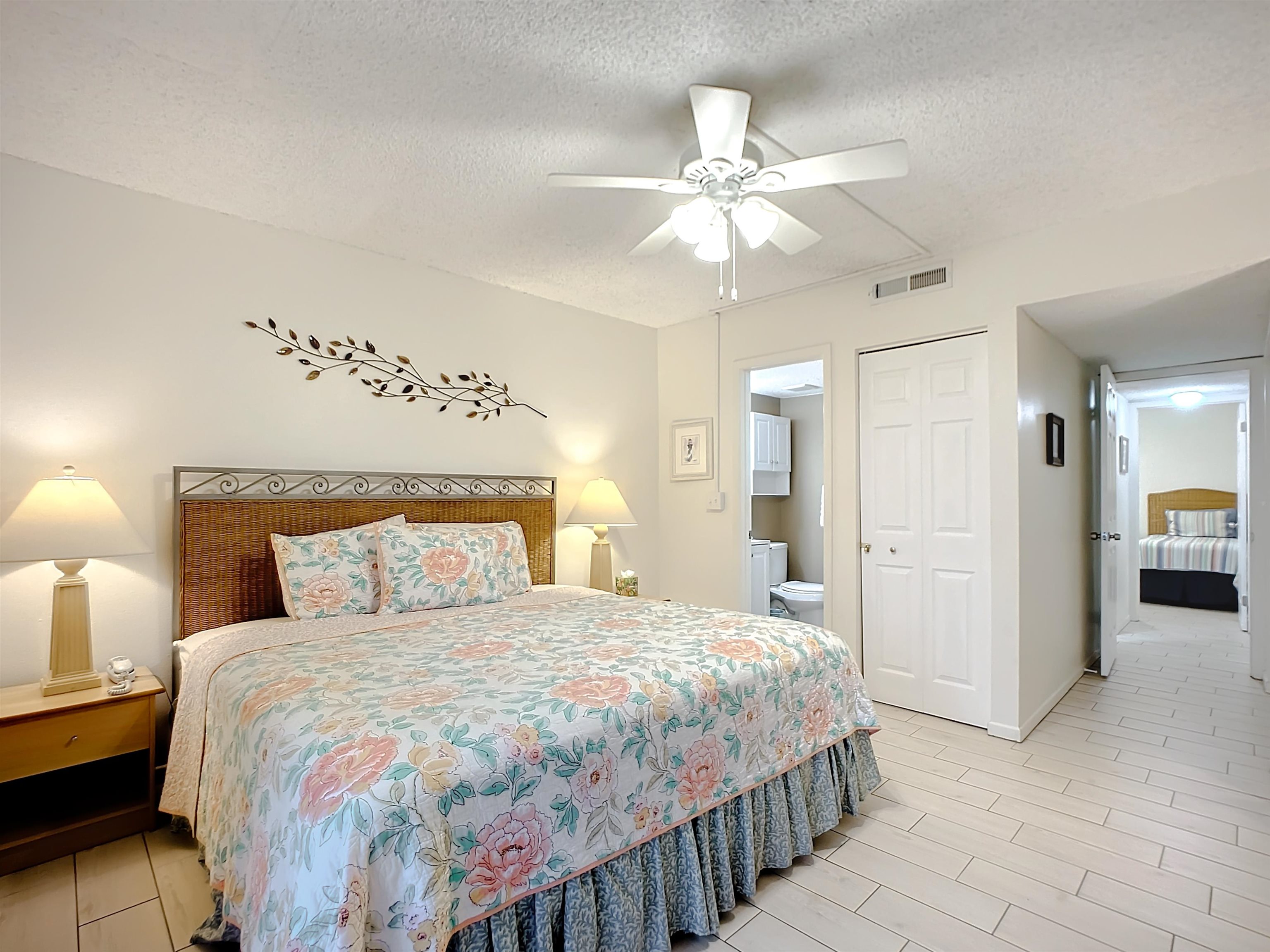 4 Ocean Trace Road, Unit 123 St. Augustine, FL 32080 - Photo 18 of 30 a bedroom with a large bed and a chandelier