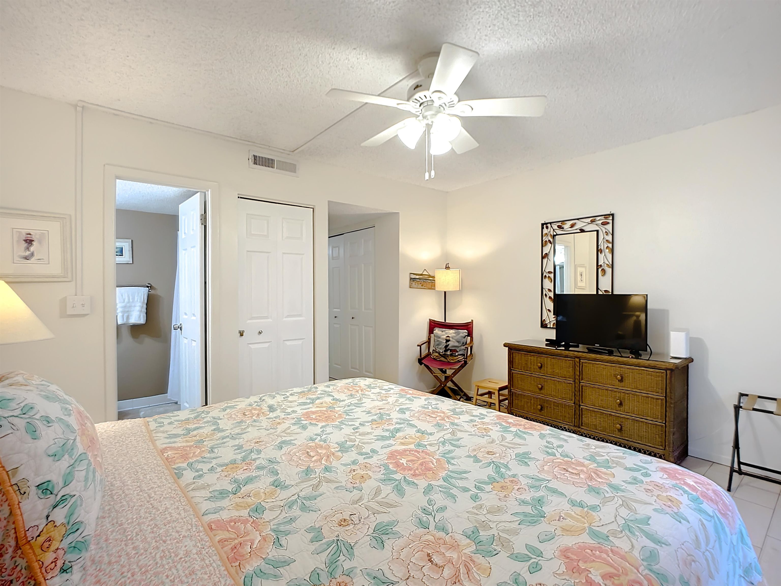 4 Ocean Trace Road, Unit 123 St. Augustine, FL 32080 - Photo 19 of 30 a bedroom with a bed and a flat screen tv