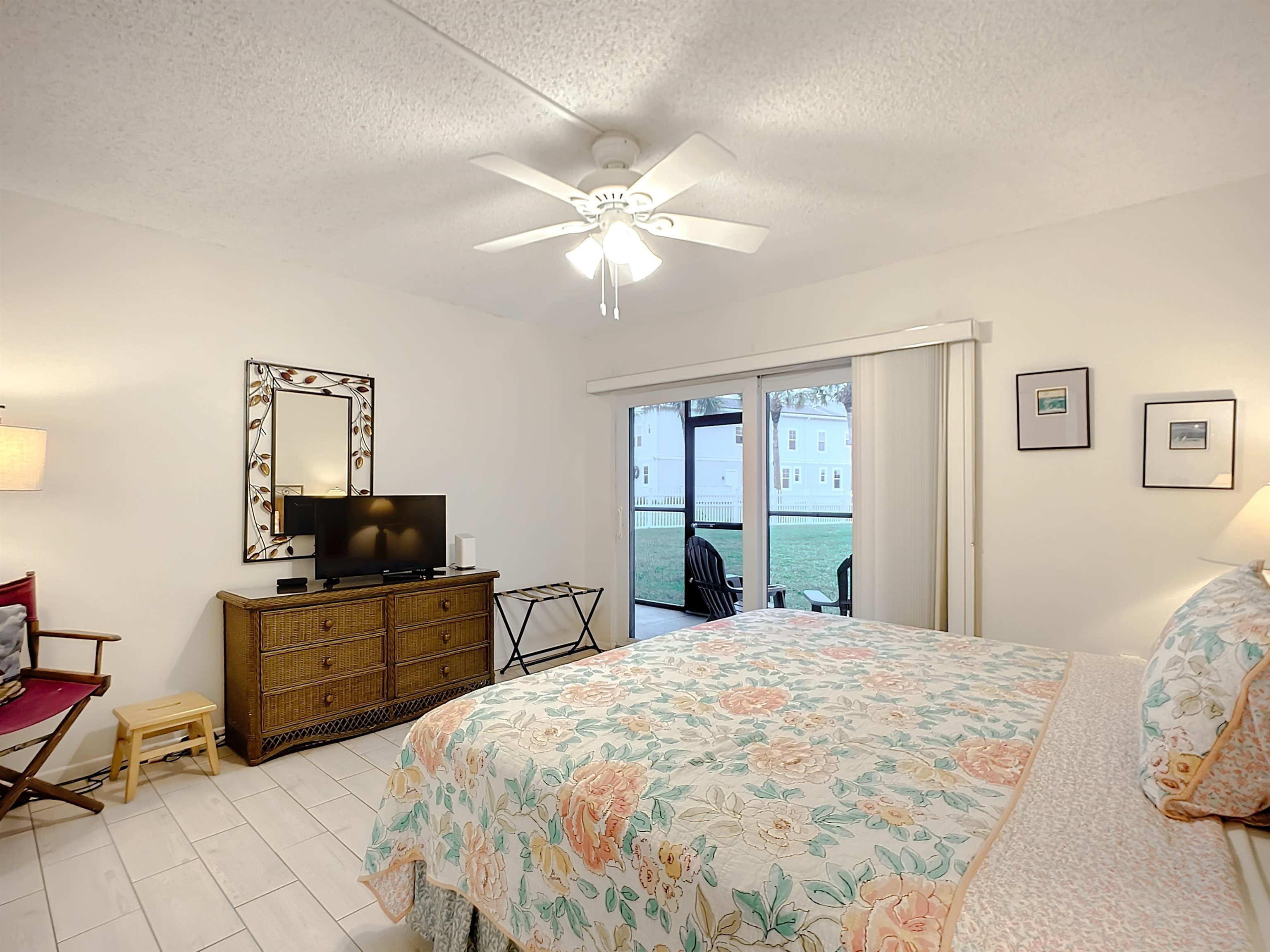 4 Ocean Trace Road, Unit 123 St. Augustine, FL 32080 - Photo 20 of 30 a bedroom with a bed and a flat screen tv