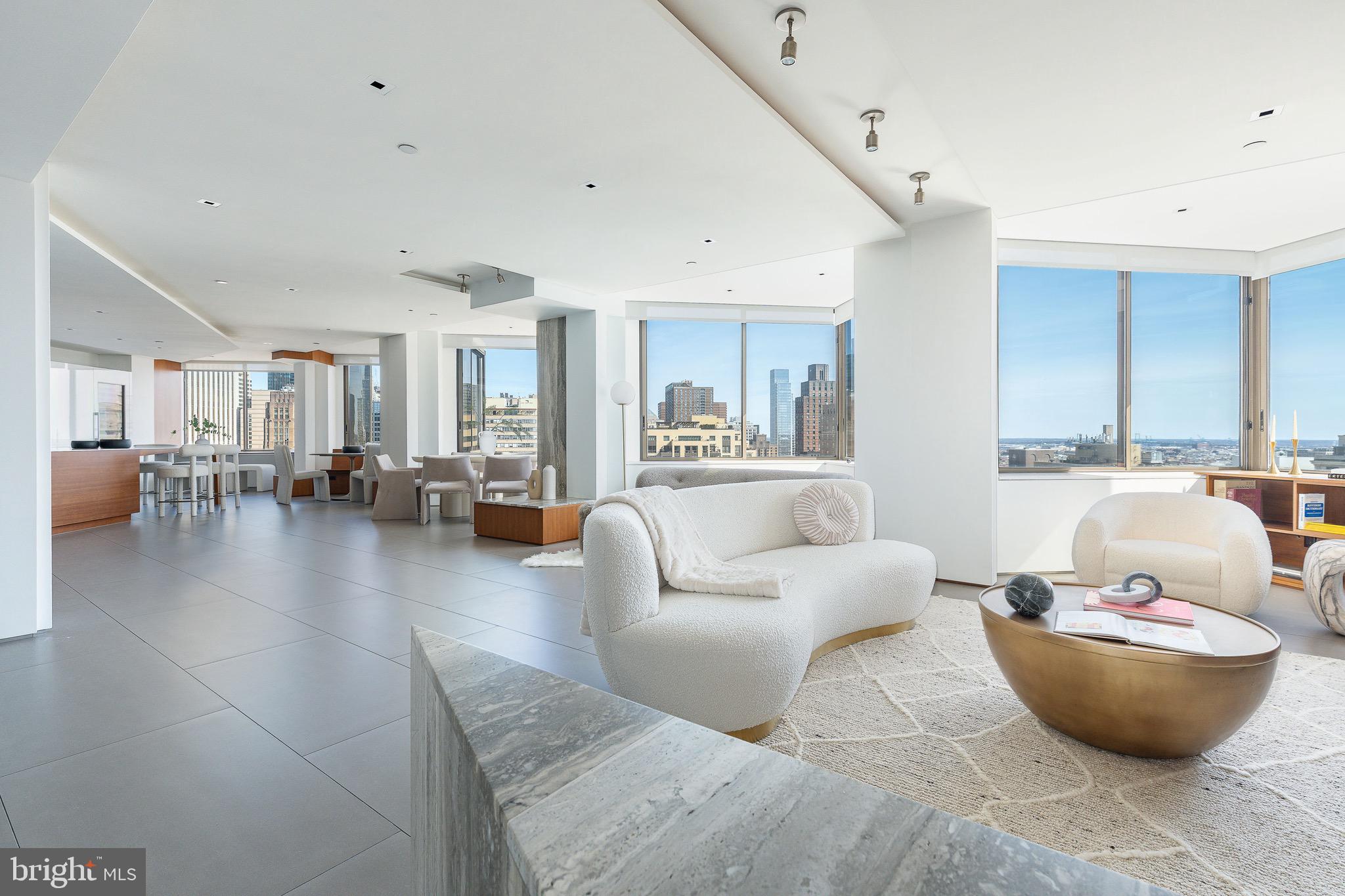a living room with furniture and view of kitchen