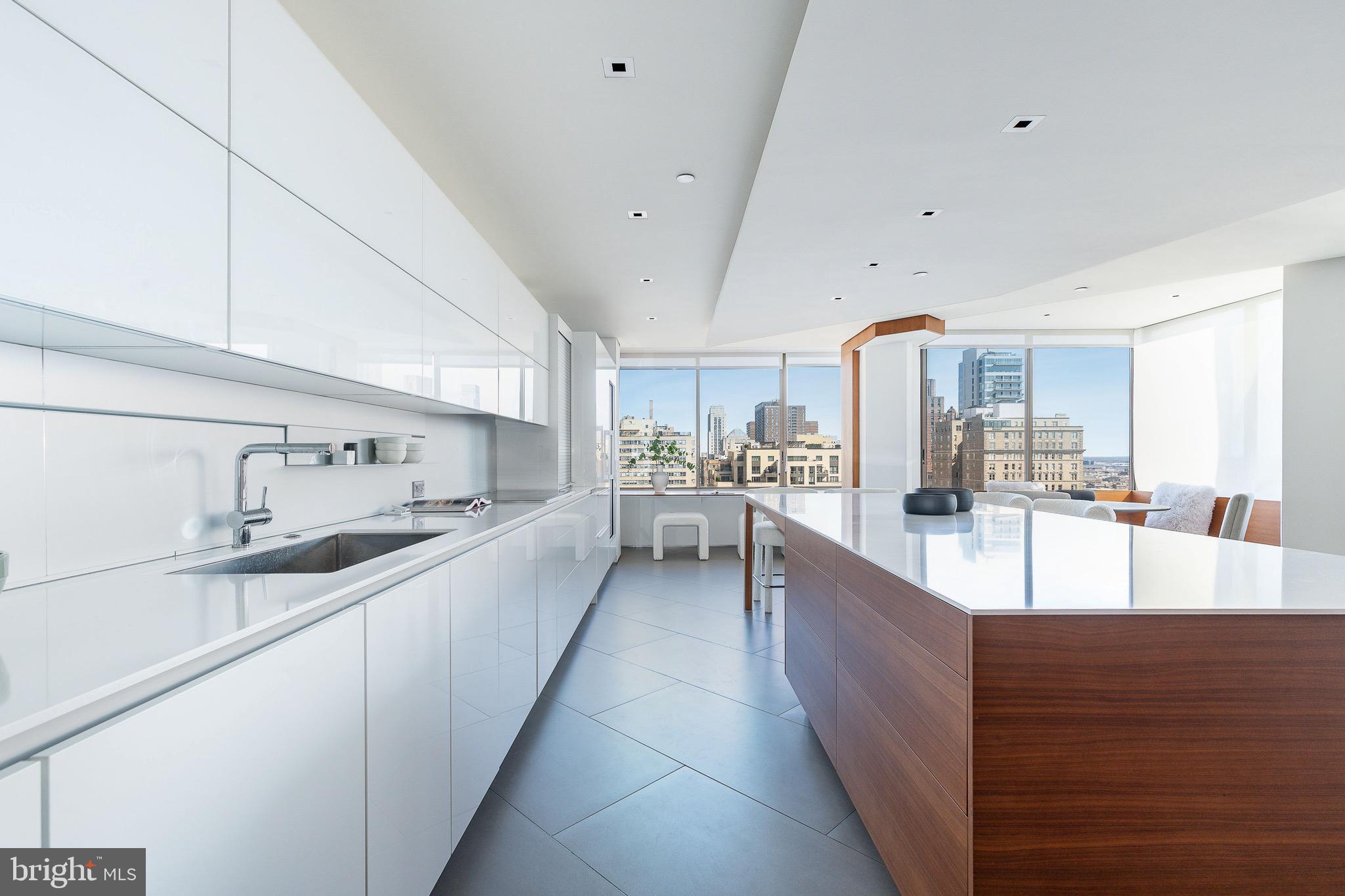 210 West Rittenhouse Square, Unit 21062107 Philadelphia, PA 19103 - Photo 11 of 74 a large kitchen with stainless steel appliances kitchen island granite countertop a large counter top a sink a stove and a refrigerator