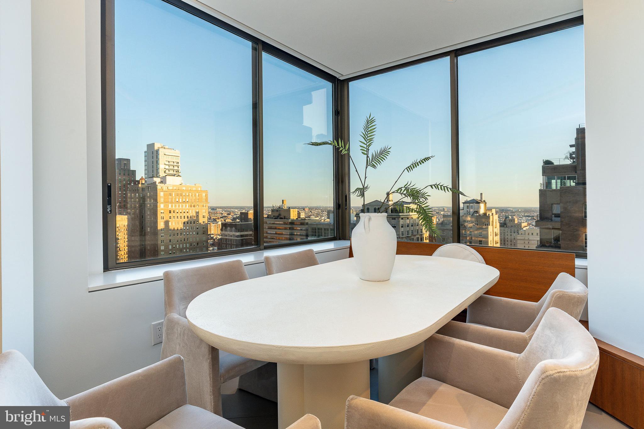210 West Rittenhouse Square, Unit 21062107 Philadelphia, PA 19103 - Photo 17 of 74 a dining room with furniture and a large window