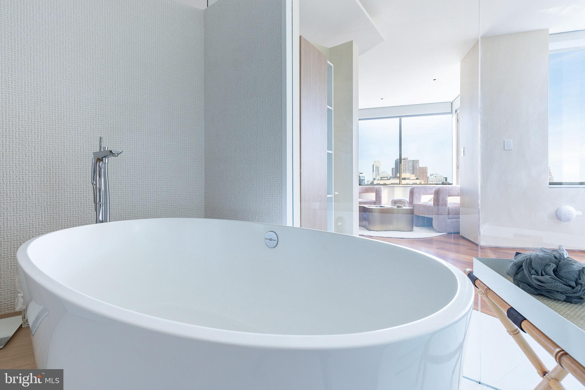 210 West Rittenhouse Square, Unit 21062107 Philadelphia, PA 19103 - Photo 42 of 74 a white bath tub sitting in a bathroom