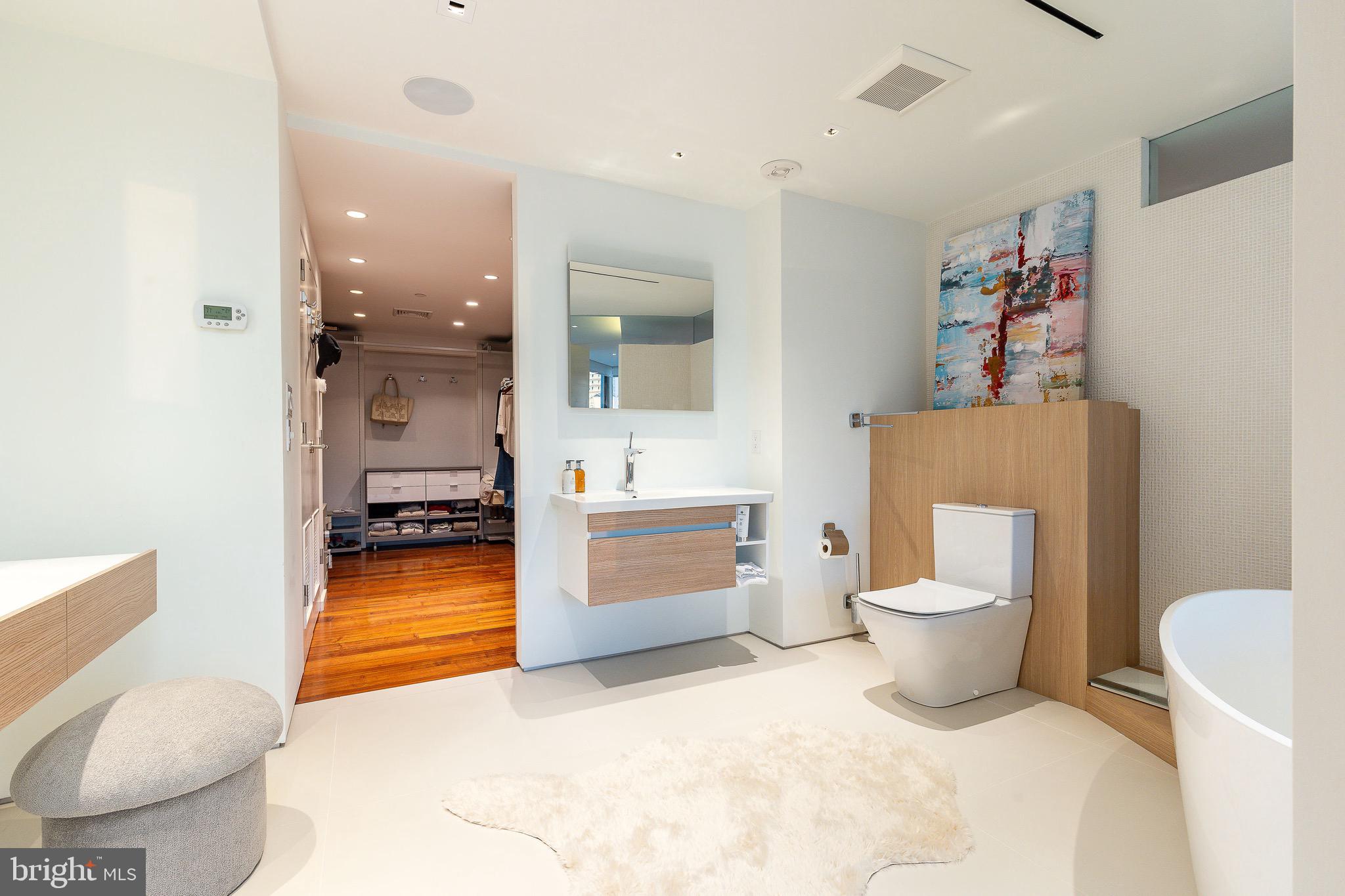 210 West Rittenhouse Square, Unit 21062107 Philadelphia, PA 19103 - Photo 44 of 74 a bathroom with a toilet sink and mirror