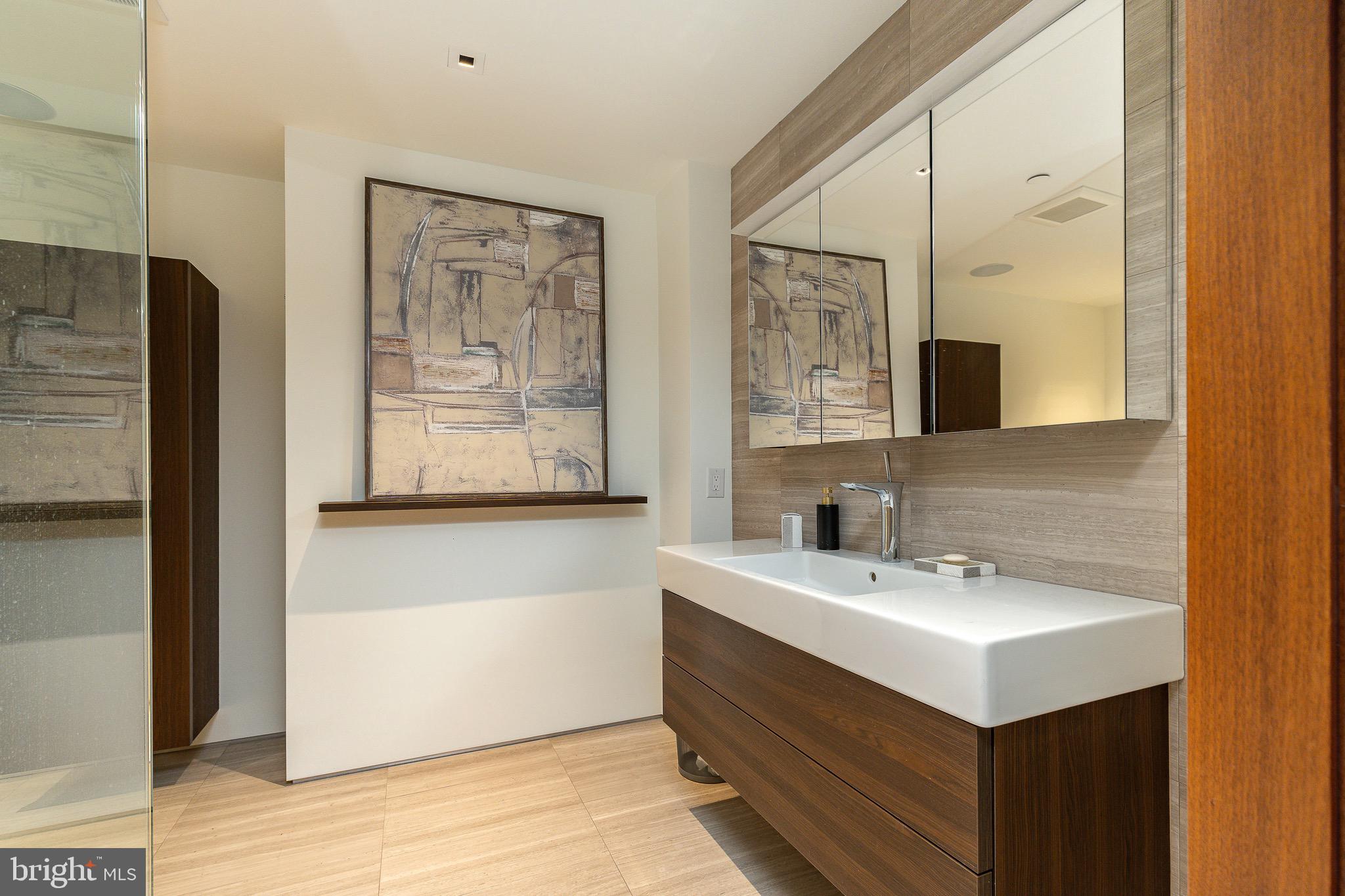 210 West Rittenhouse Square, Unit 21062107 Philadelphia, PA 19103 - Photo 49 of 74 a bathroom with a sink and a mirror