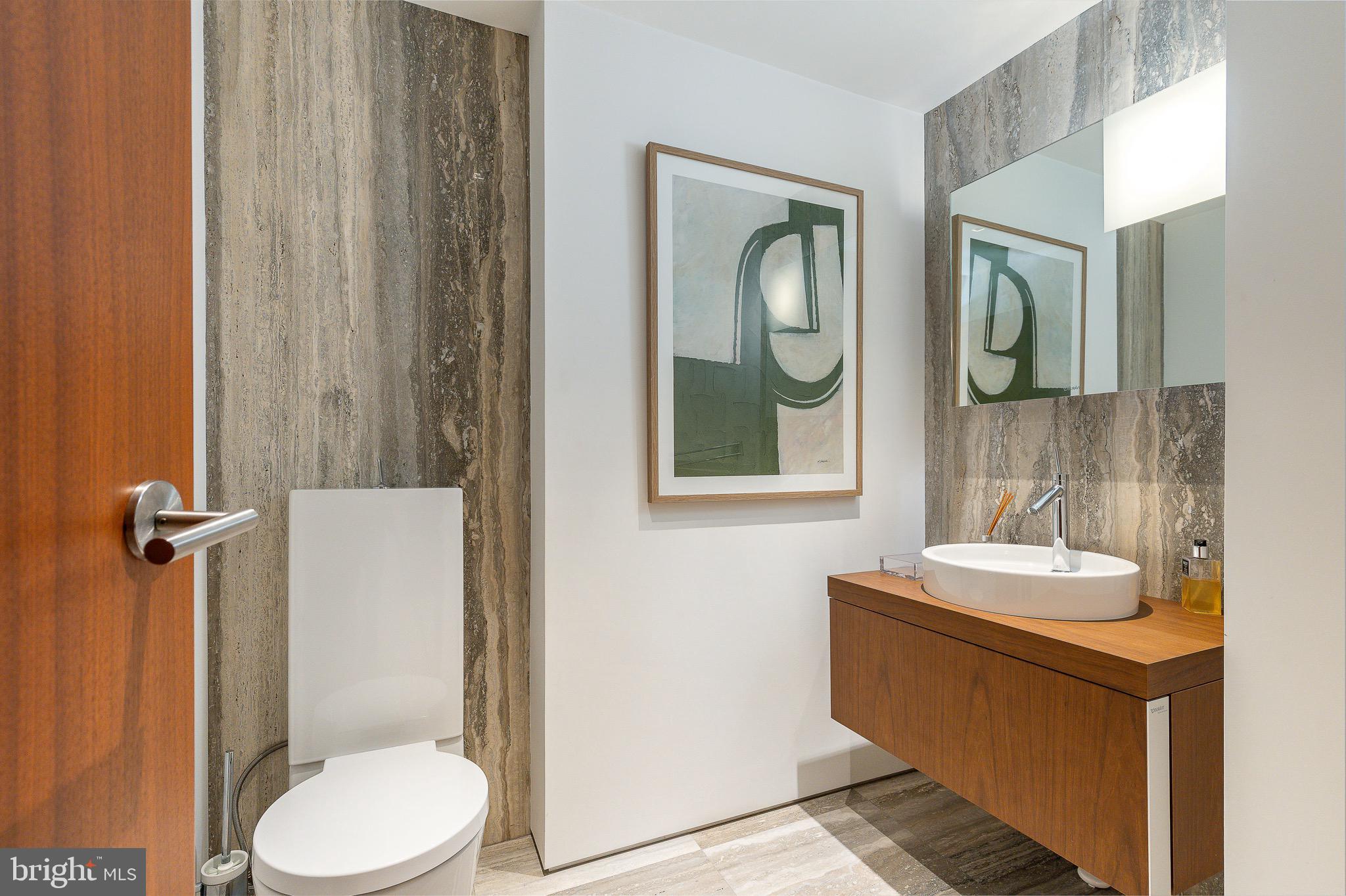 210 West Rittenhouse Square, Unit 21062107 Philadelphia, PA 19103 - Photo 6 of 74 a bathroom with a toilet a sink and mirror