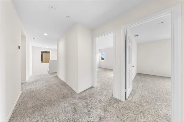 an empty room with a bathroom and a sink