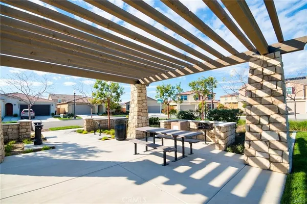 a view of a patio with a table and chairs and potted plants