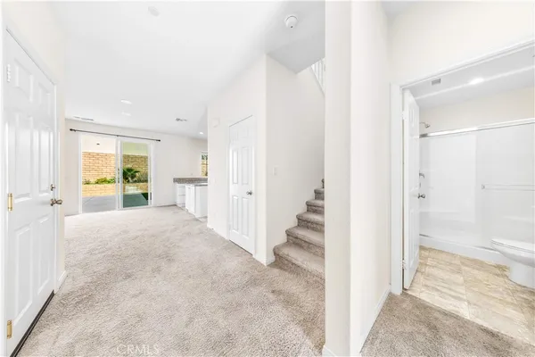 a view of a big room with windows and wooden floor