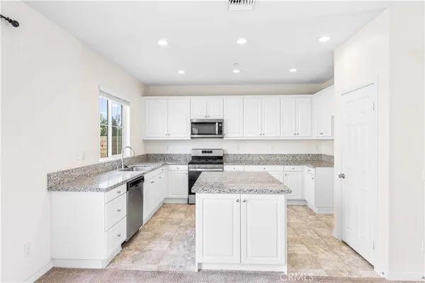 a kitchen with a sink stove and cabinets