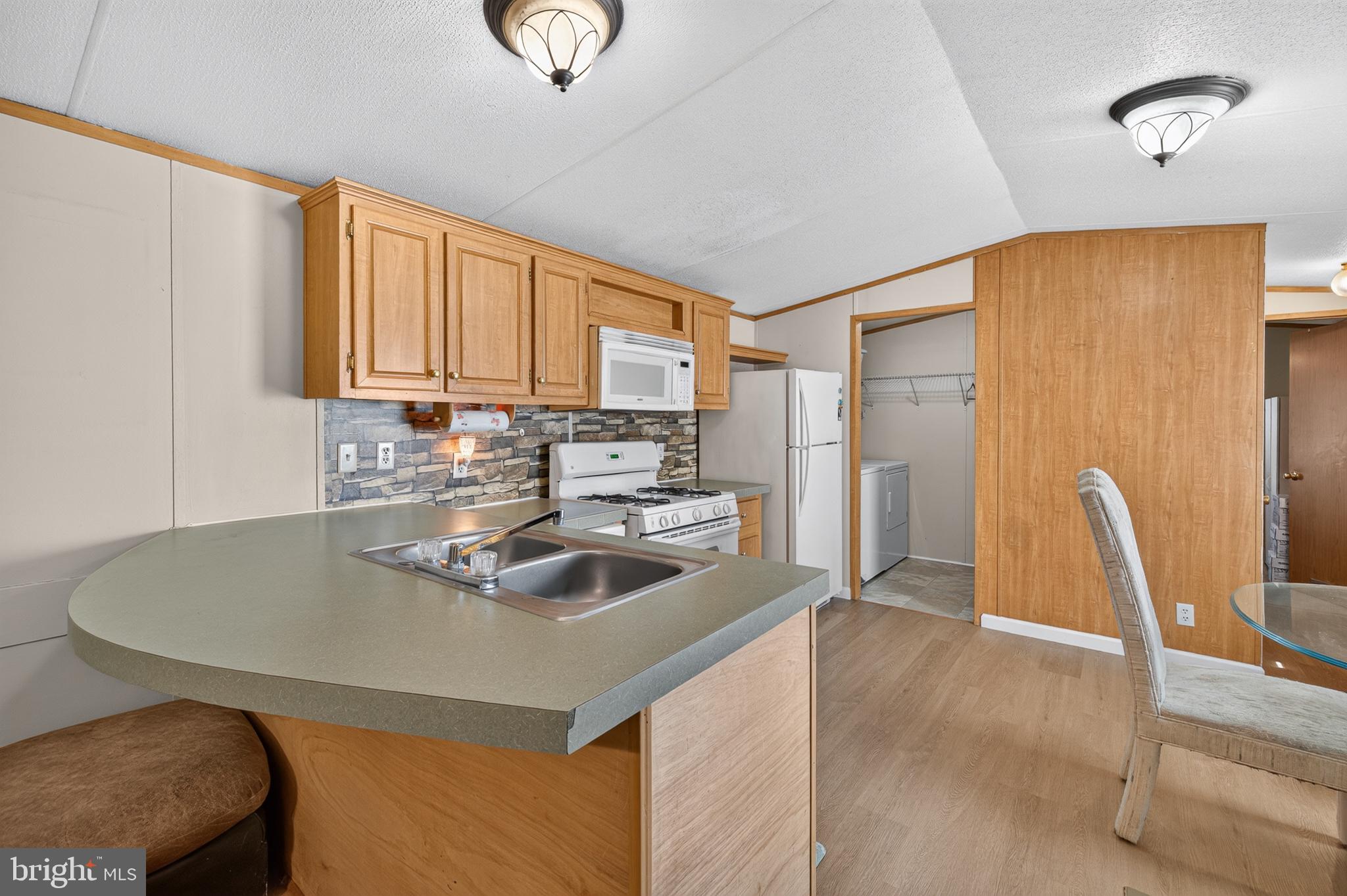 8 West Reybold Drive, Unit 8 Middletown, DE 19709 - Photo 5 of 30 Modern kitchen with warm wood accents.