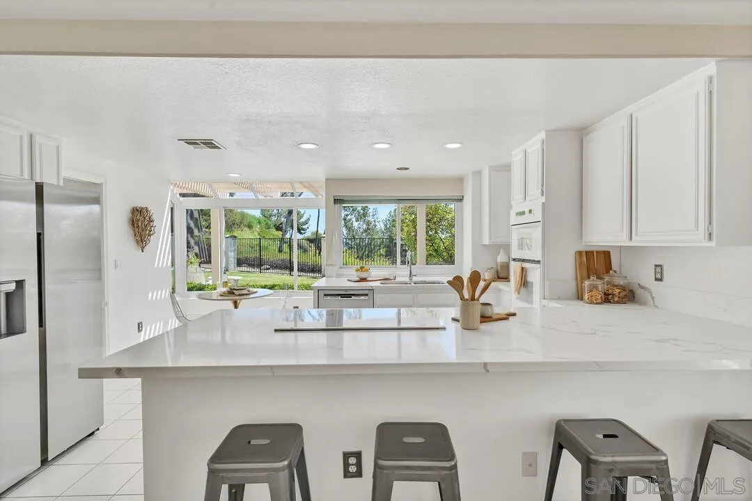 7967 Wing Span Drive San Diego, CA 92119 - Photo 12 of 45 a kitchen with counter top space cabinets and stainless steel appliances