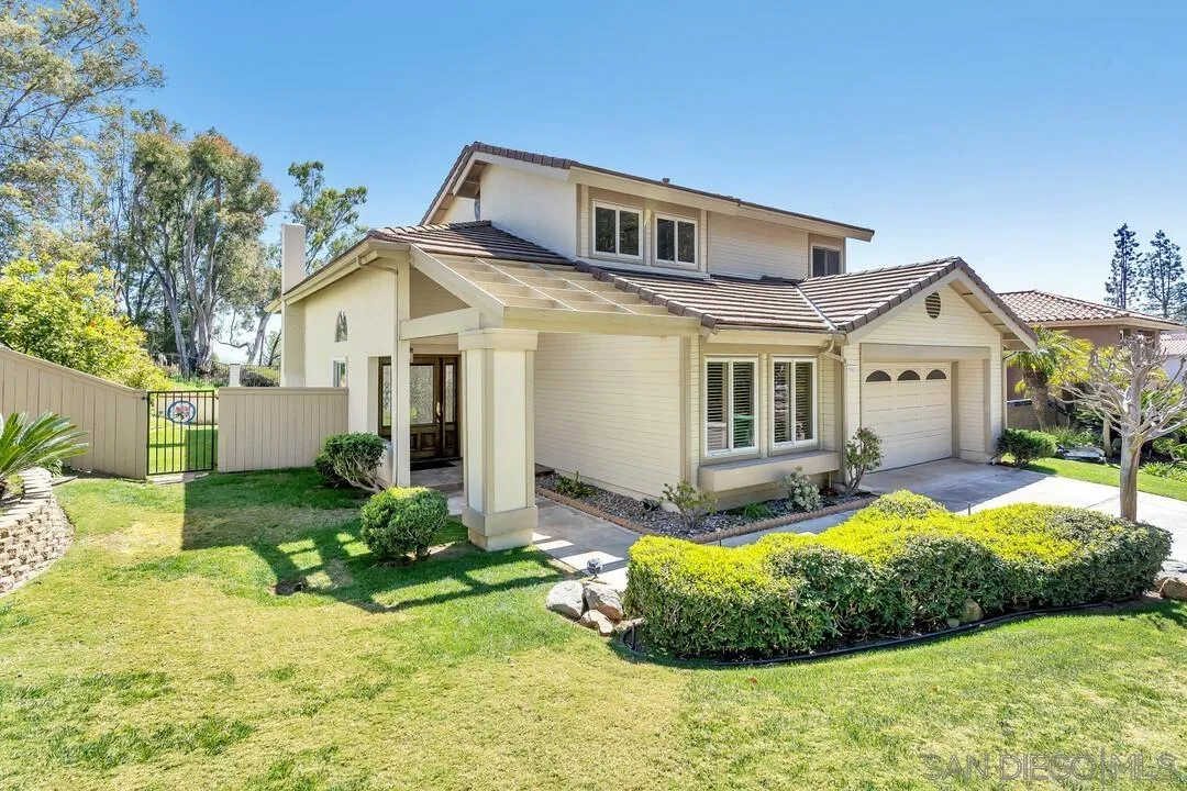 7967 Wing Span Drive San Diego, CA 92119 - Photo 2 of 45 a front view of a house with a yard and porch