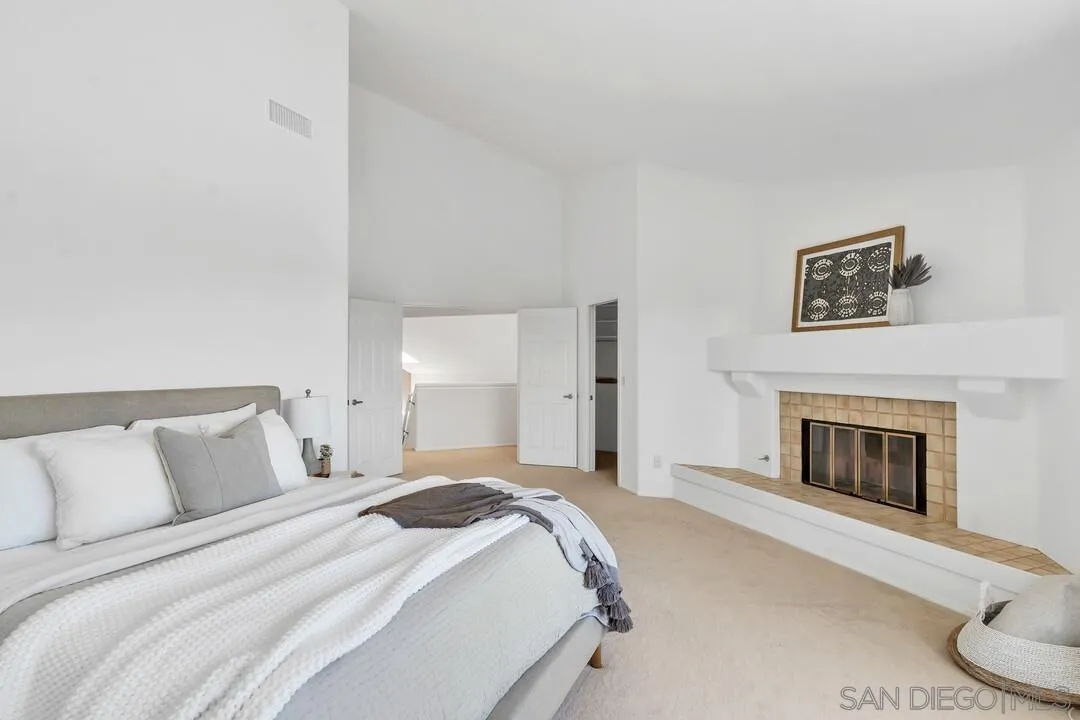 7967 Wing Span Drive San Diego, CA 92119 - Photo 26 of 45 a spacious bedroom with a bed and a fireplace