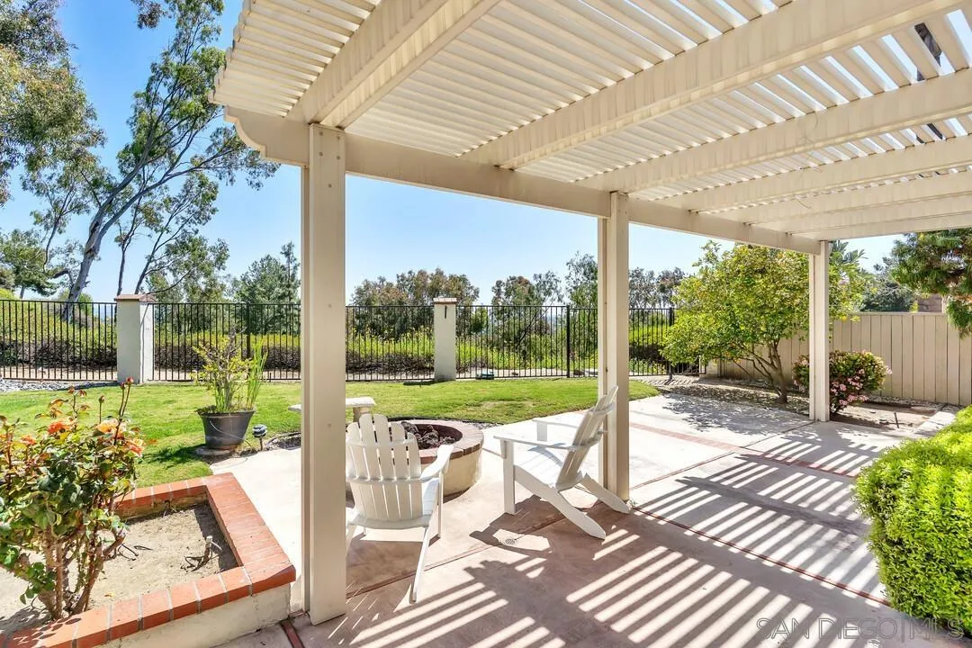 7967 Wing Span Drive San Diego, CA 92119 - Photo 38 of 45 a view of a patio with a table chairs and a backyard
