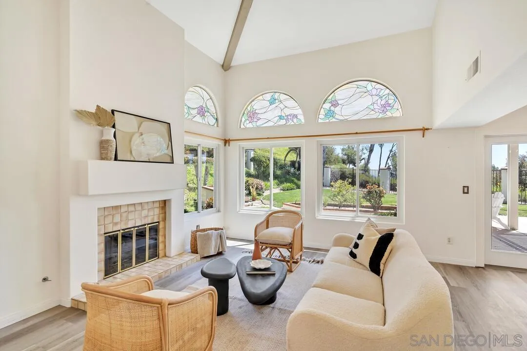 7967 Wing Span Drive San Diego, CA 92119 - Photo 4 of 45 a living room with furniture a fireplace and a large window