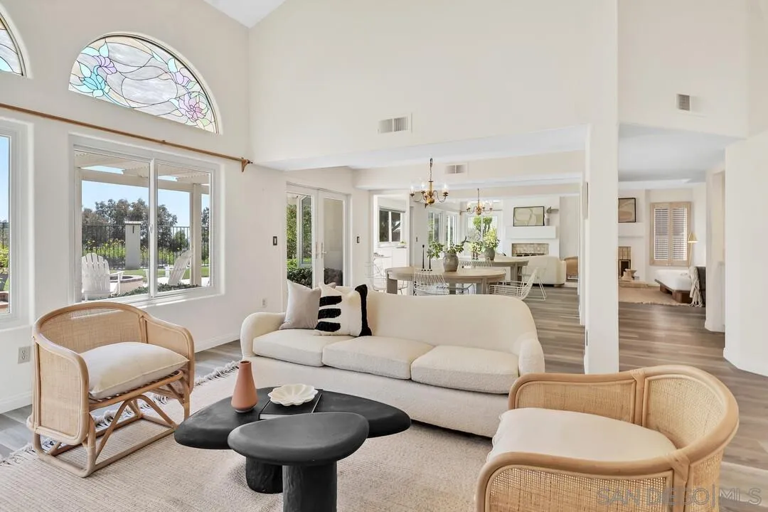 7967 Wing Span Drive San Diego, CA 92119 - Photo 5 of 45 a living room with furniture a large window and a chandelier