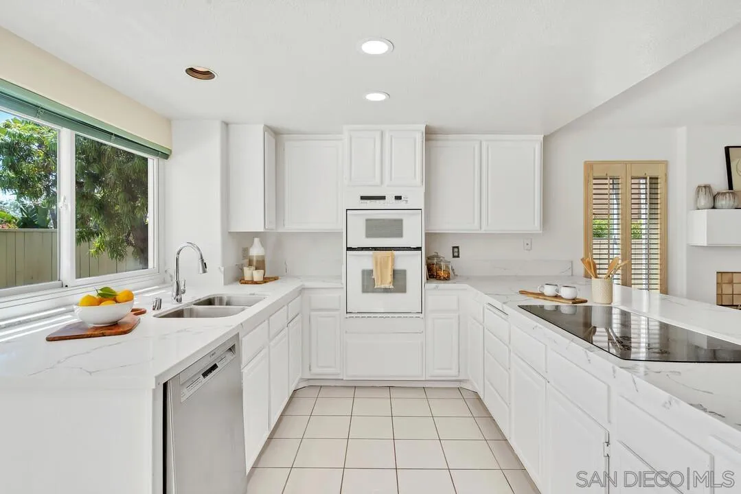 7967 Wing Span Drive San Diego, CA 92119 - Photo 10 of 45 a kitchen that has a sink and a stove in it
