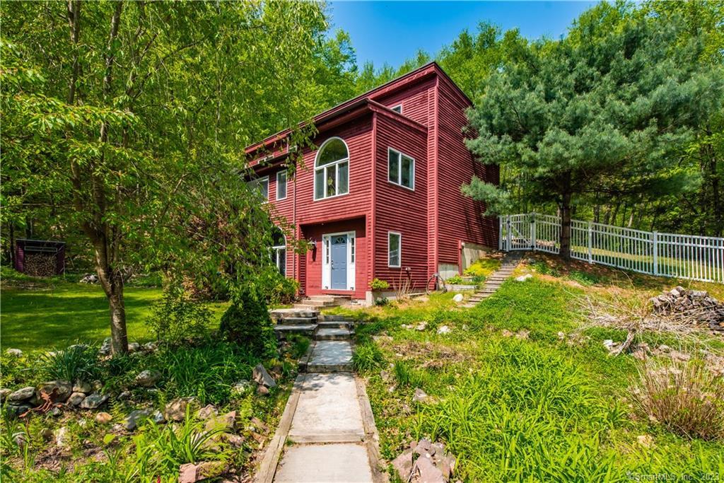 a view of a house with a yard and garden
