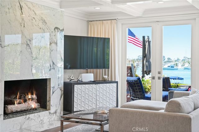 a dining room with furniture a chandelier and wooden floor