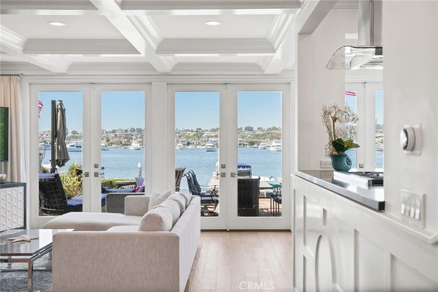 a kitchen with granite countertop a white sink a stove and cabinets