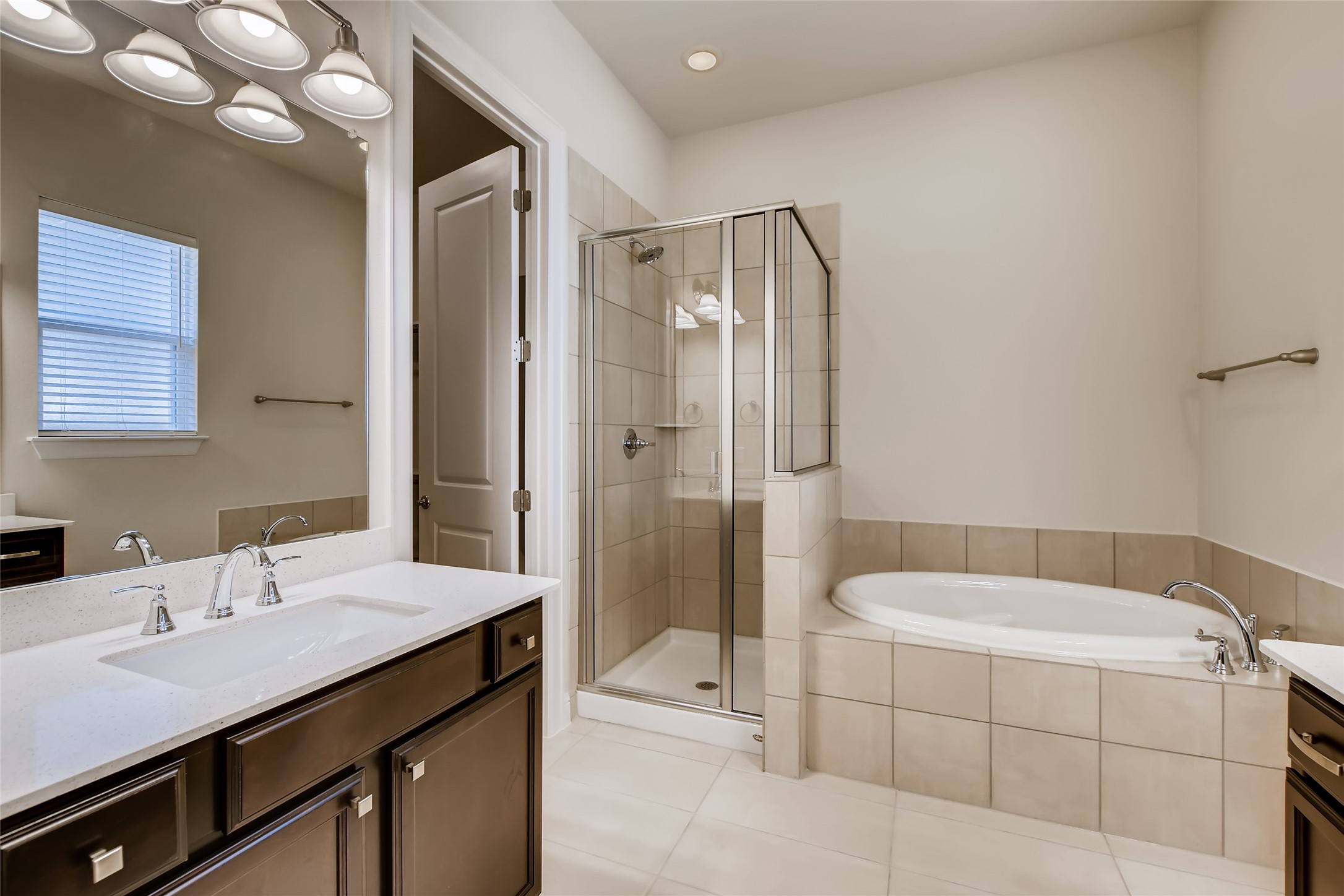 601 C-Bar Ranch Trail, Unit 28 Cedar Park, TX 78613 - Photo 19 of 27 Primary Bath features dual vanities, walk-in shower, and garden tub.