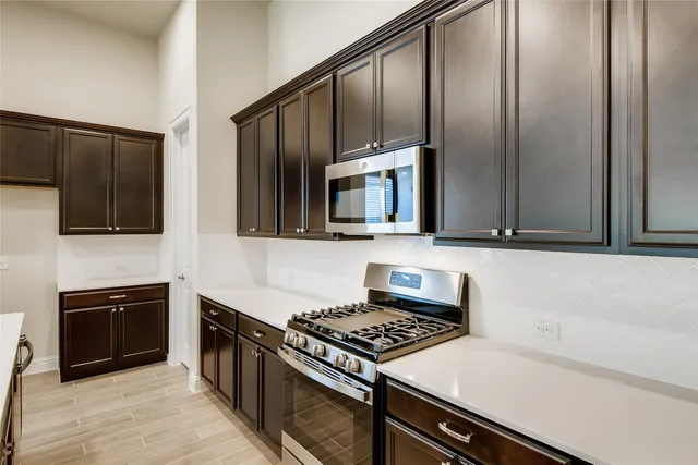 a kitchen with stainless steel appliances and cabinets