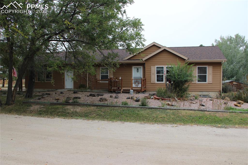 749 B 9th Street Calhan, CO 80808 - Photo 2 of 46 a front view of house with yard and trees