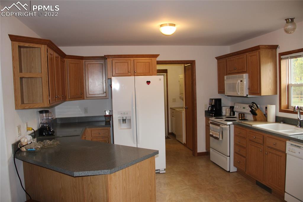 749 B 9th Street Calhan, CO 80808 - Photo 3 of 46 a kitchen with stainless steel appliances granite countertop a sink stove and refrigerator