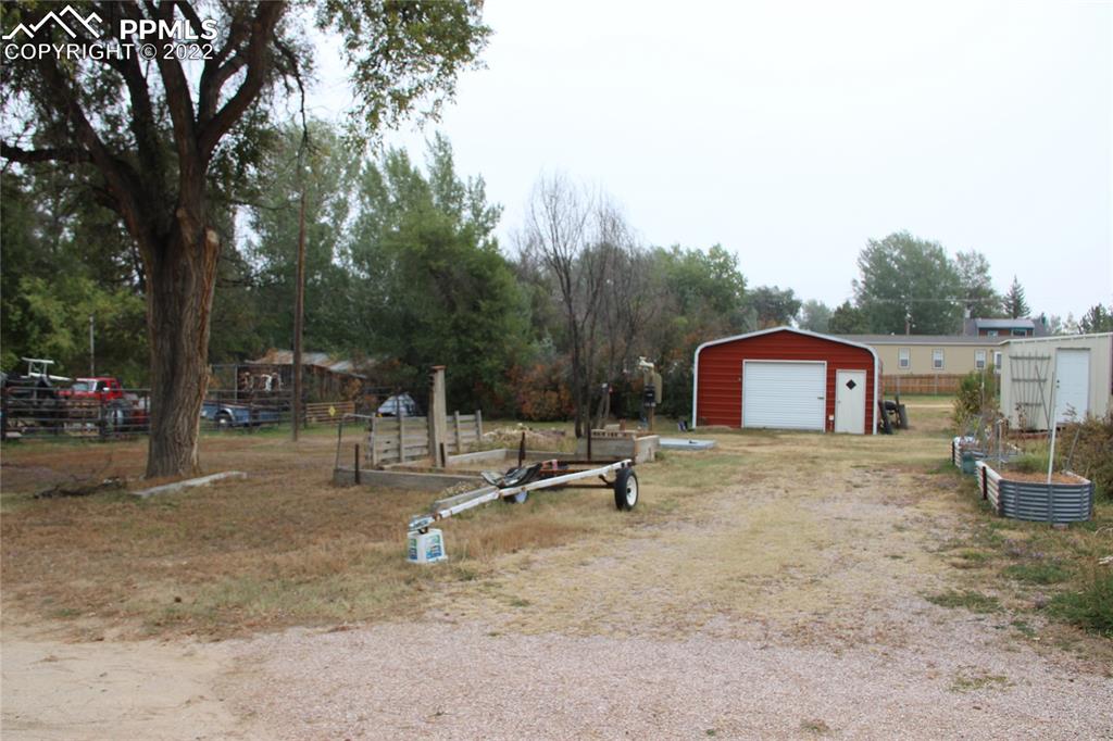 749 B 9th Street Calhan, CO 80808 - Photo 43 of 46 a view of a fire pit with a tree
