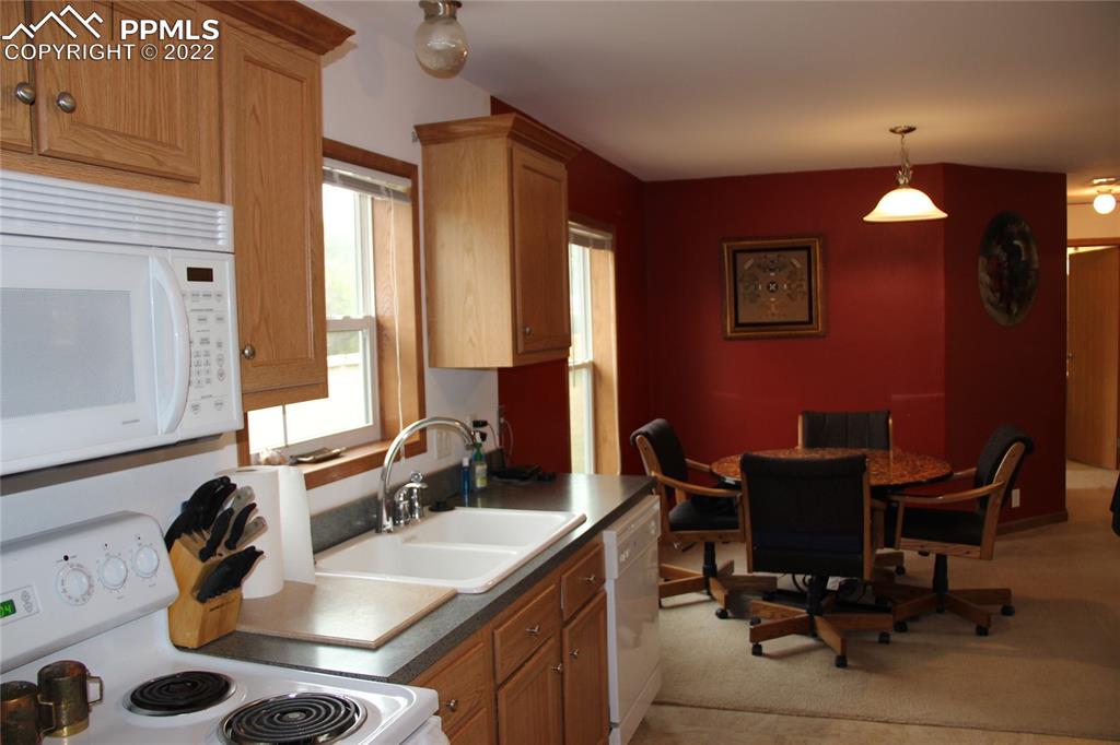 749 B 9th Street Calhan, CO 80808 - Photo 9 of 46 a view of a workspace with furniture and a window