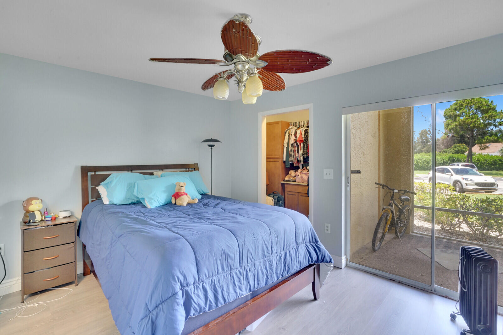 4855 Via Palm Lakes, Unit 902 West Palm Beach, FL 33417 - Photo 12 of 24 a bedroom with a bed and a chandelier