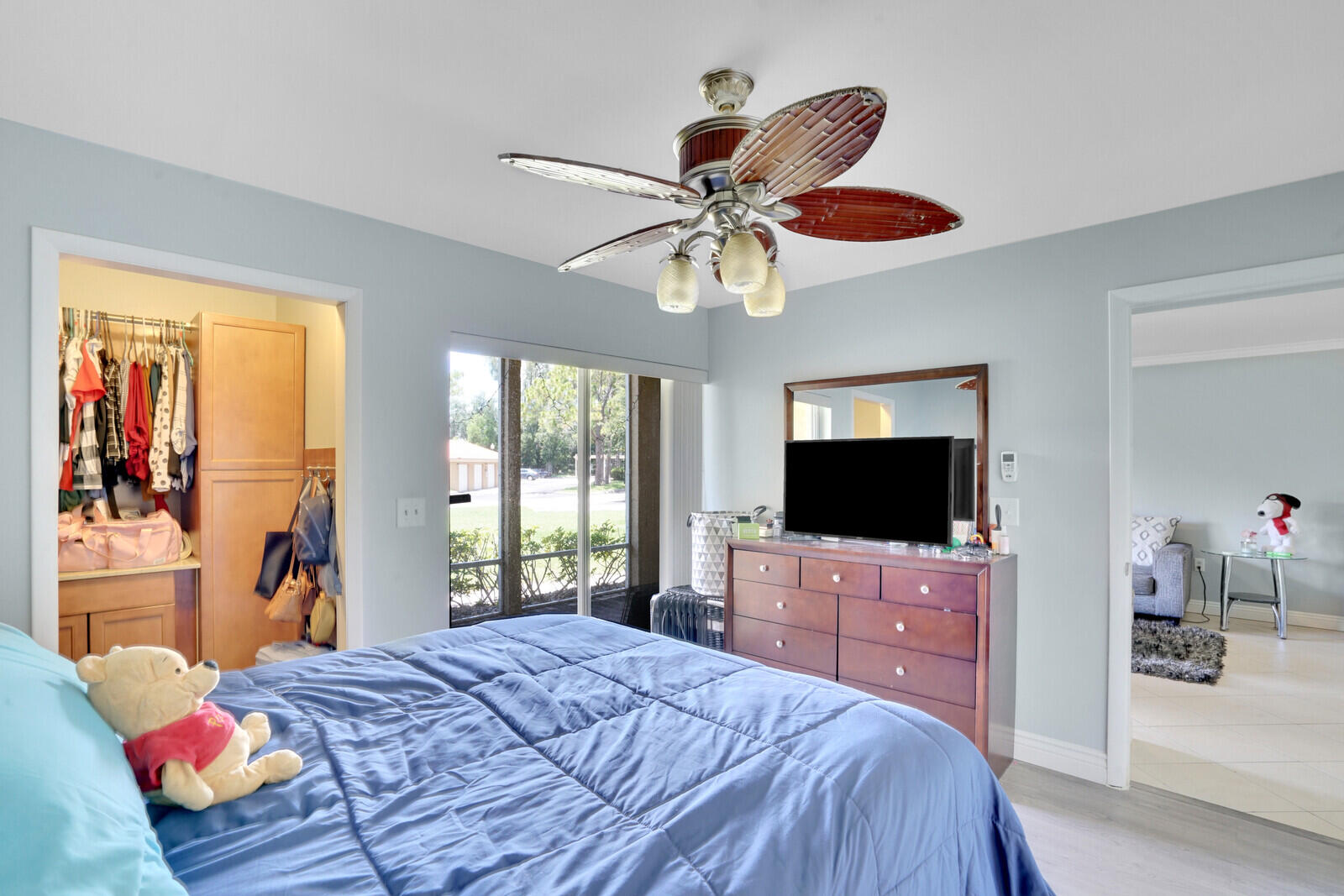 4855 Via Palm Lakes, Unit 902 West Palm Beach, FL 33417 - Photo 13 of 24 a bedroom with a bed and a flat screen tv