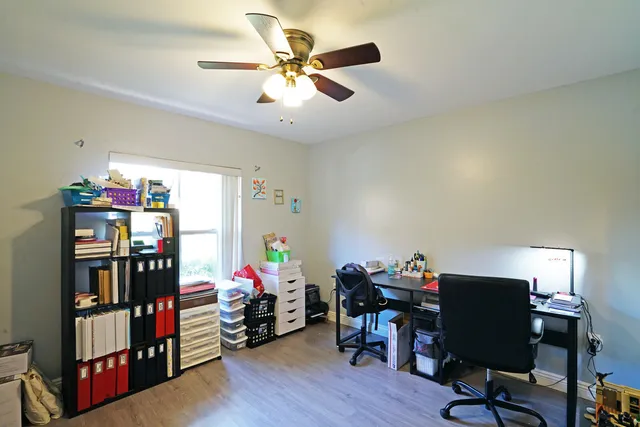 a view of a workspace with furniture and a window
