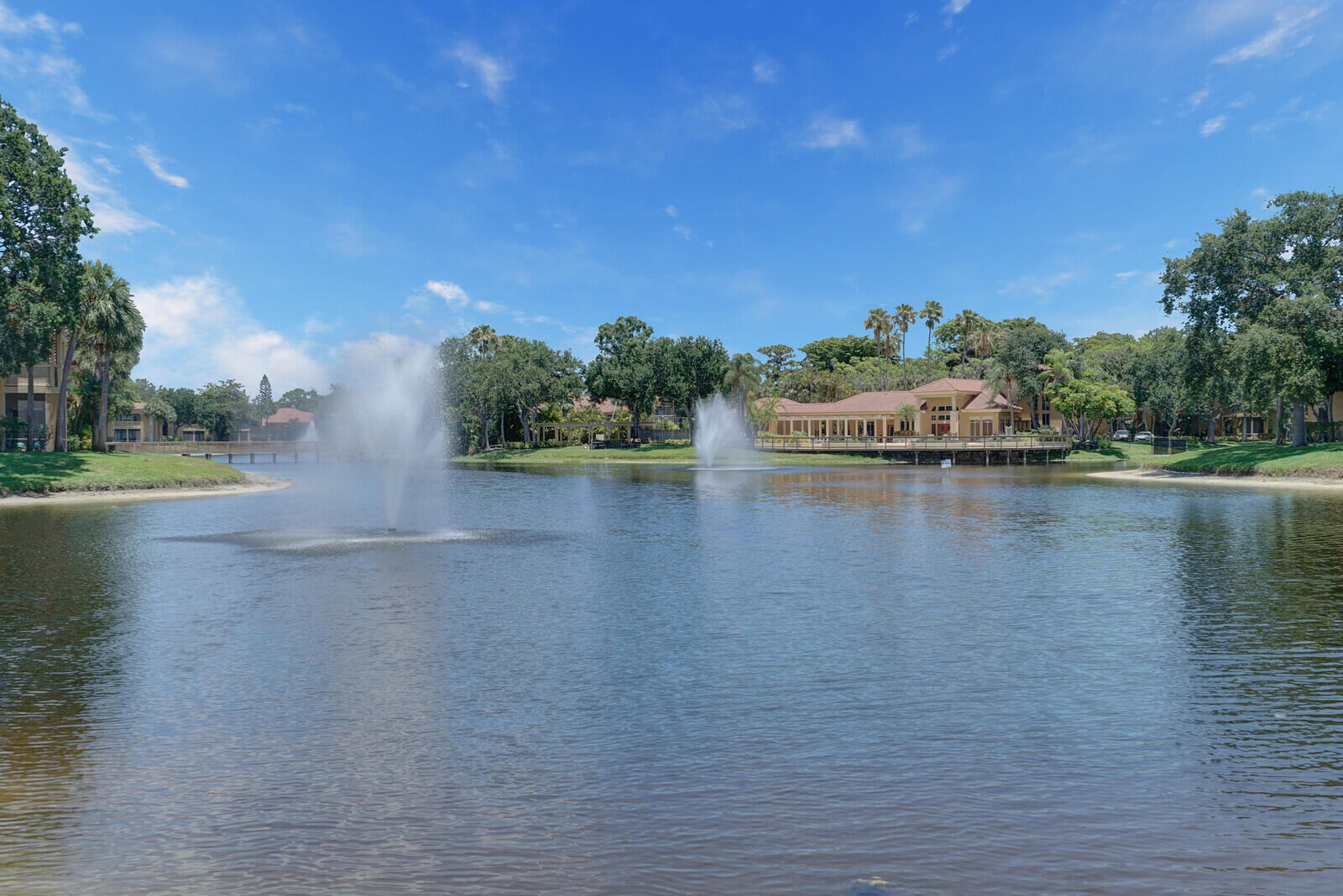 4855 Via Palm Lakes, Unit 902 West Palm Beach, FL 33417 - Photo 21 of 24 a view of a lake with houses