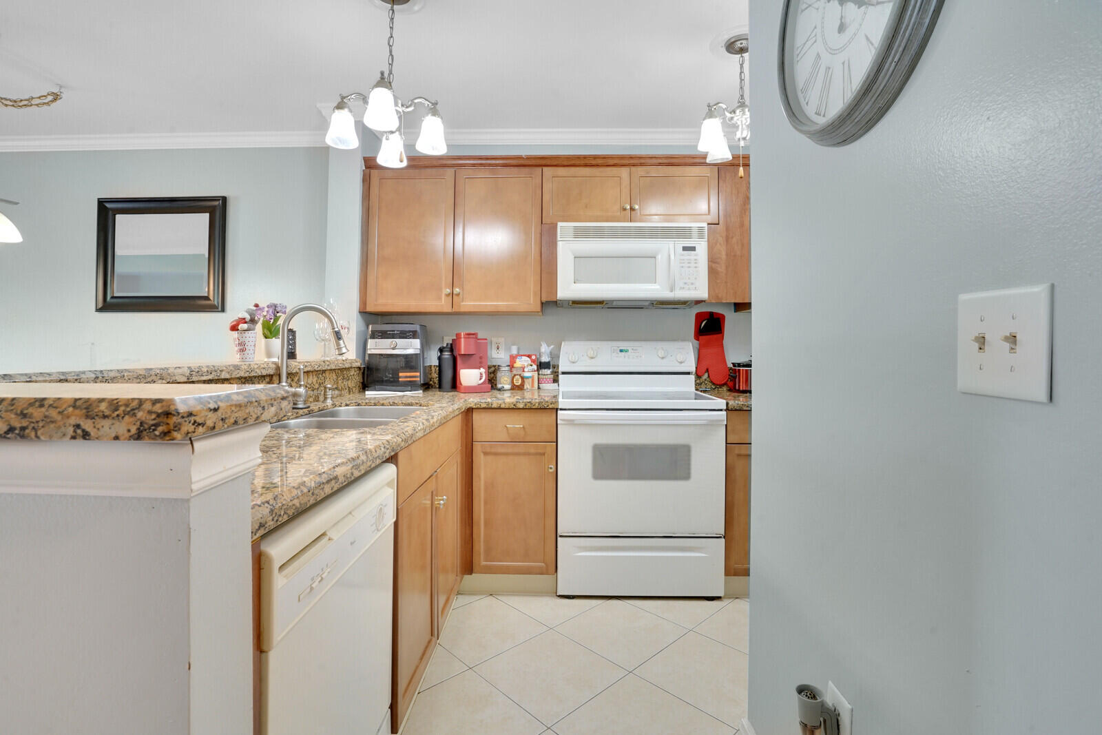 4855 Via Palm Lakes, Unit 902 West Palm Beach, FL 33417 - Photo 3 of 24 a kitchen with appliances a sink and a stove