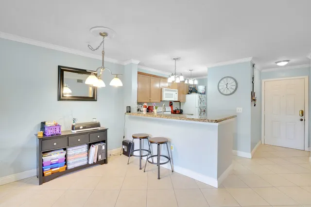 a kitchen with cabinets and chairs