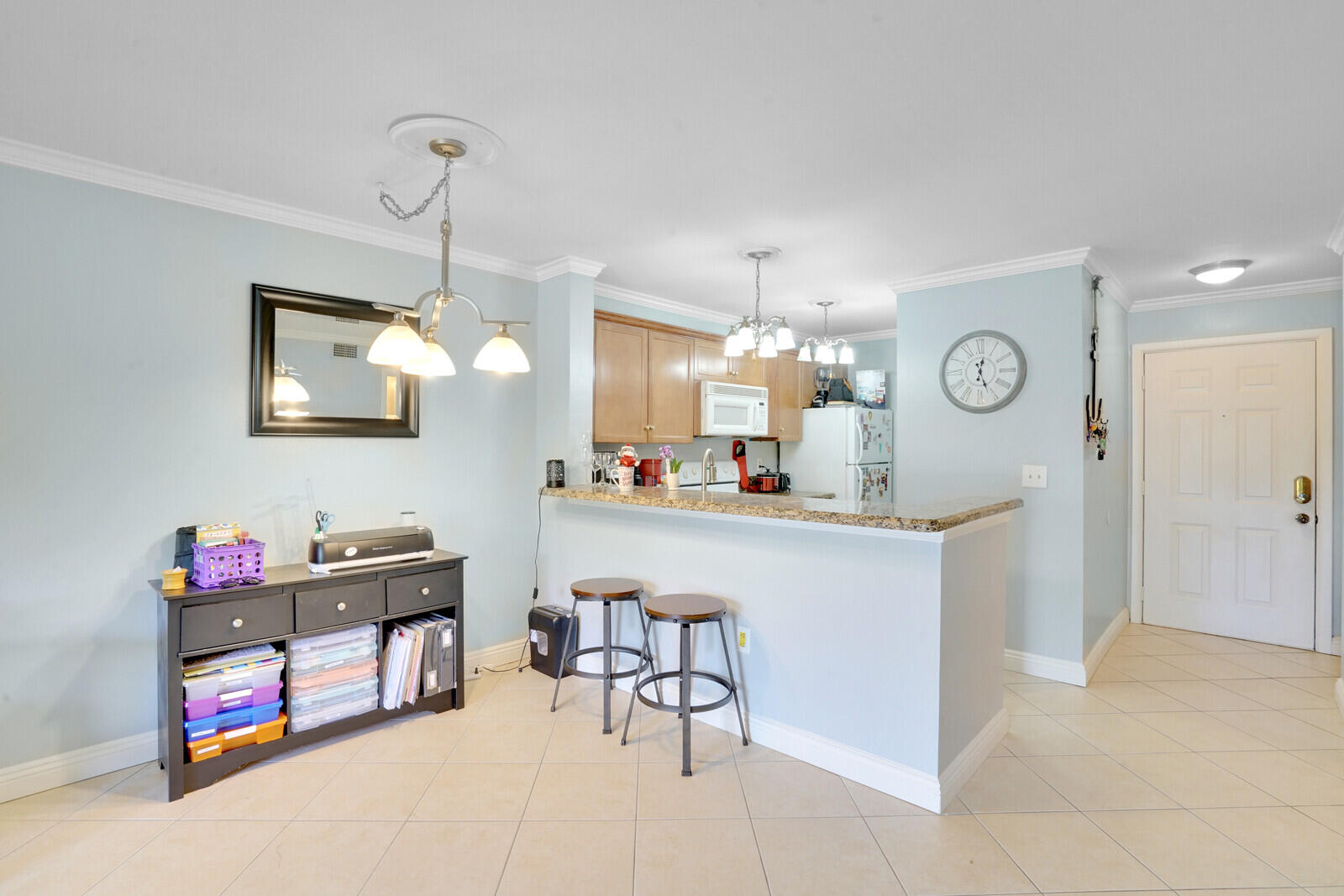 4855 Via Palm Lakes, Unit 902 West Palm Beach, FL 33417 - Photo 9 of 24 a kitchen with cabinets and chairs