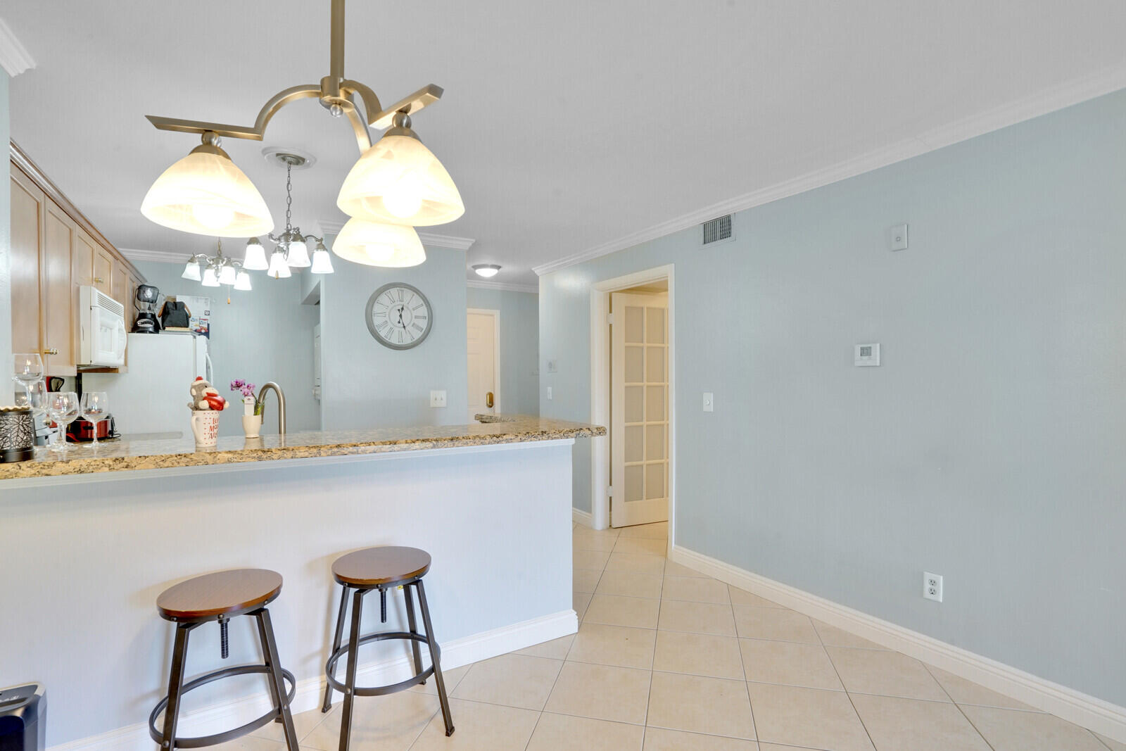 4855 Via Palm Lakes, Unit 902 West Palm Beach, FL 33417 - Photo 10 of 24 a view of a dining room and kitchen